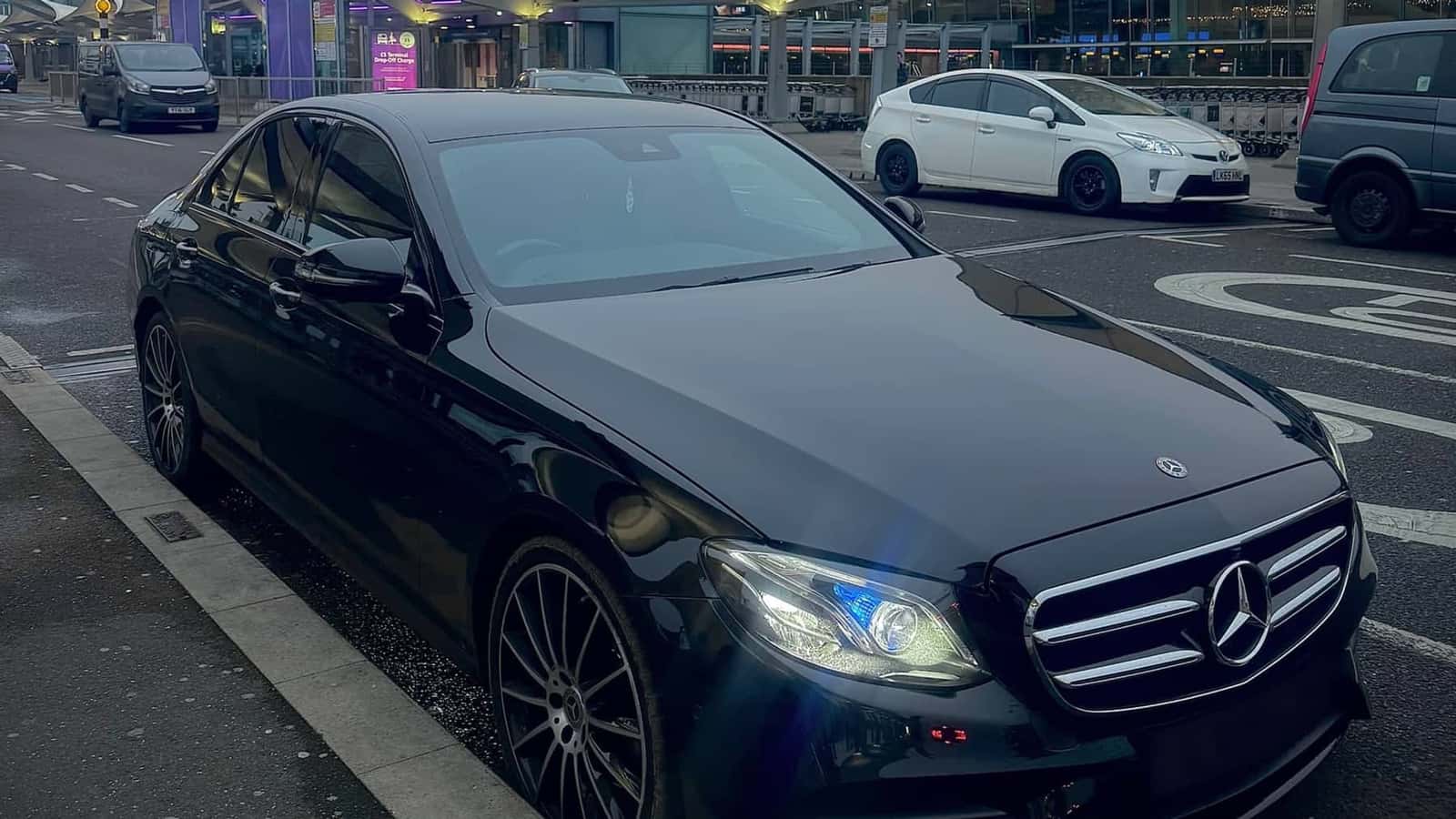 Elite Ride Mercedes-Benz on a city street at dusk